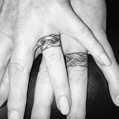 two people with wedding rings on their fingers, one holding the other's hand