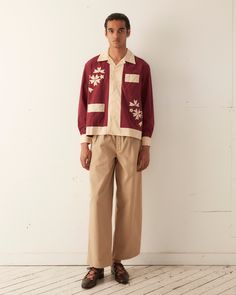 This long sleeve shirt is inspired by a 1950s tablecloth. The appliqué motif is a faithful reproduction of the original tablecloth featuring cream flowers and a wide border on a maroon ground.  Boxy, cropped fit Four front buttons  Two front pockets  100% cotton  Made in India  Dry Clean only  View all Shirts All wear, Long Sleeve Button Up Shirt Outfit, Bode Shirt, Maroon Shirt Outfit, New York Shopping, Shirt Outfit Men, Maroon Shirts, Mens Casual Dress Outfits, Applique Shirts, Cream Flowers