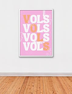 a pink poster hanging on the wall in an empty room with wooden floors and hard wood flooring