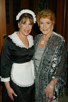 two women standing next to each other in formal wear