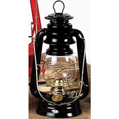 a black and gold lantern sitting on top of a table