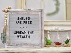 a sign that says smiles are free spread the wealth