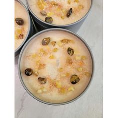 three pots filled with food sitting on top of a table