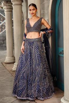 Navy blue attached can-can lehenga with beads, cutdana, crystal and sequin work. Comes with padded blouse and dupatta.
Component: 3
Pattern: Embroidered
Type Of Work: Beads, Cutdana, Crystal and Sequin
Neckline: V neck
Sleeve Type: Sleeveless
Fabric: Net
Color: Blue
Other Details: 
Blouse with bead tassels
Bead with cutwork border
Low back with tassels
Closure: Back hook
Occasion: Bride - Aza Fashions Dupatta With Belt, Blue Net Lehenga, Tulle Lehenga, Blouse Yoke, Net Lehenga, Blue Tulle, Abstract Geometric Pattern, How To Make Clothes, Bridal Lehenga