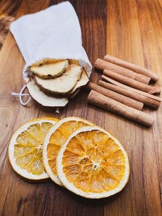 sliced oranges and cinnamon sticks on a wooden table