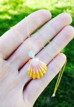 This lovingly handmade necklace is made with 24K gold filled wire and chain, a gorgeous AAA quality sunrise shell and a lovely sparkling AAA gemstone of your choice. Shown on image one with Ocean blue AAA Aqua marine and AAA Rainbow moonstone on image 2. I will create a custom made necklace just for you with your choice of your favorite Gemstone and your choice of shell (Picked from image). Available with a beautiful AAA Rainbow Moonstone, Labradorite, Amethyst or Aqua Marine. Also available with a lovely petite fresh water pearl as shown on image 3-6. Scroll  to pick your pearl or Gemstone and favorite shell! Every shell and stone is truly unique for a one if a kind creation! ✨ ️  Sunrise shells are so stunning and very hard to find and they are exclusive to the Hawaiian island's north sh Sunrise Shell, Aqua Marine, Moonstone Necklace, Shell Necklace, Diy Crafts Jewelry, Wrapped Jewelry, Pearl Gemstone, Unique Gemstones, Shell Necklaces