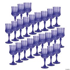 a bunch of wine glasses sitting next to each other on a white surface with no one in the photo