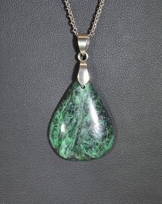 This jade is known among lapidary artists as being some of if not the best in the world for stone jewelry. This piece is a great example of the color and character of Maw Sit Sit which comes from Burma. While most all of it is nice I prefer the dark green/black examples of it which are more rare. Maw Sit Sit is made up of ureyite, jadeite and feldspar. This pendant is paired with stainless steel (bail and chain). In the global market we encourage you to shop local by supporting artists and small Color Jade, Manufactured Stone, Jade Necklace, Small Containers, Support Artists, Jade Jewelry, Shop Local, Global Market, Green Jade