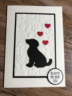 a card with a black dog and hearts on it's side, which says sorry for your loss