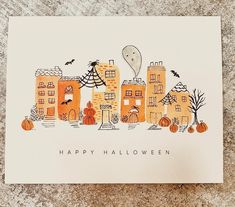 a happy halloween card with an image of houses and pumpkins on the front in orange