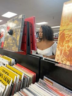 a woman looking at records in a record store