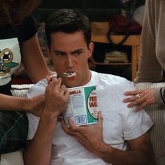 a man eating cereal while sitting on a couch