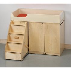 a wooden desk with drawers underneath it and a red drawer on the bottom right side