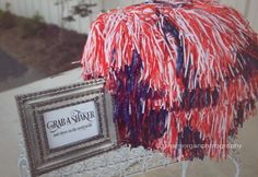 a red, white and blue table cloth on a metal stand with a silver frame