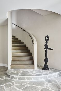 a staircase leading up to the top of a set of stairs in a home with stone steps