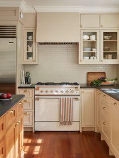 a white stove top oven sitting inside of a kitchen