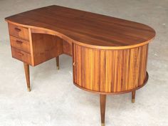 a wooden desk sitting on top of a white floor