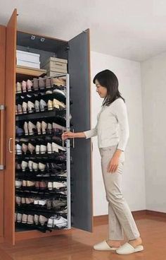 a woman standing in front of a shoe rack