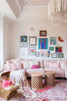 a living room filled with lots of furniture and pictures on the wall above it's couches