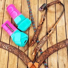 three different colored leashes laying on top of a wooden floor next to each other