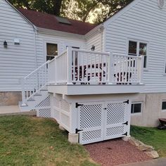 a white house with a deck in front of it