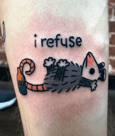 a person with a tattoo on their leg that says i refuse, and a rat