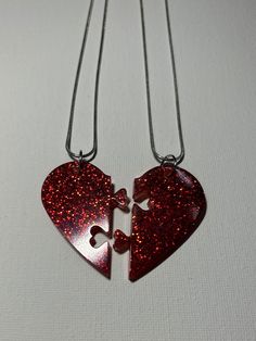 For sale is a handmade matching set of resin puzzle heart necklaces. They are colored red with red sparkles in them. The dimensions are 1 3/4" wide (together) and 1 3/4" long. The chain is 9" long. Please see all pictures for details. Feel free to contact me if you have any questions or would like to order your own style :) Handmade Red Heart Necklace For Valentine's Day, Personalized Red Double Heart Jewelry, Heart-shaped Resin Necklace For Valentine's Day, Valentine's Day Heart-shaped Resin Necklace, Valentine's Day Resin Jewelry With Heart Charm, Heart Shaped Resin Jewelry For Valentine's Day, Heart-shaped Resin Jewelry For Valentine's Day, Personalized Heart Shaped Resin Jewelry, Personalized Red Heart Necklace