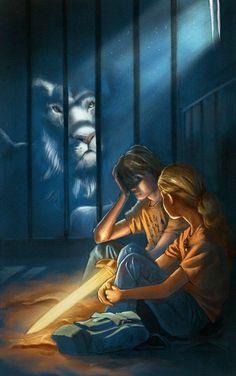 two children sitting on the ground in front of a caged area with a lion