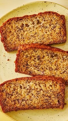 three slices of bread sitting on top of a white plate with black speckles