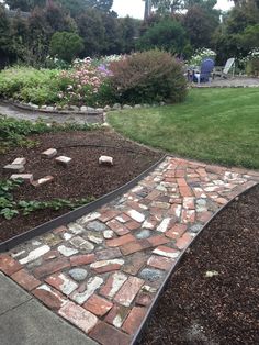 a stone path in the middle of a garden