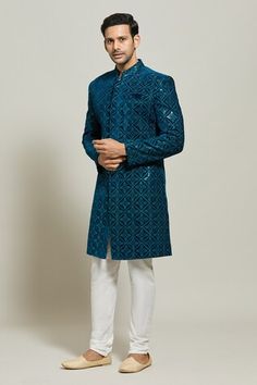 Blue sherwani featuring geometric floral pattern in thread and sequin work. Paired with a white churidar. - Aza Fashions Blue Sherwani With Mirror Work For Eid, Festive Blue Embroidered Sherwani, Wedding Blue Bandhgala With Mirror Work, Blue Bandhgala With Mirror Work For Wedding, Wedding Blue Sherwani With Mirror Work, Transitional Blue Embroidered Sherwani, Festive Blue Sherwani With Cutdana Detailing, Blue Fitted Sherwani With Cutdana, Semi-stitched Blue Sherwani With Cutdana