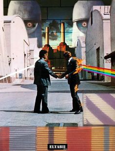 two men shaking hands in front of an industrial building