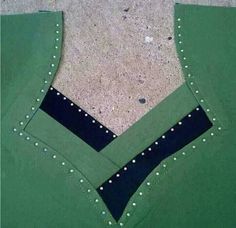 a piece of green fabric with black and white stitching