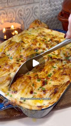 a person cutting into a casserole dish with a knife