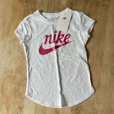 Nwt Nike The Nike Tee Shortleeve White Crewneck With Nike Pink Graphic On Front, Size 6x (6-7 Years Old), Cotton T-Shirt, Sold As Pictured No Known Flaws Or Imperfections. *Non-Smoking Pet Free Home Nike White Tops For Summer, White Fitted Top With Logo Print, White Nike Tops For Spring, Cute White Top With Logo Print, Basic White Shirt For Spring, White Basic Shirt For Spring, Nike Fitted Graphic Print Top, Nike Fitted Top With Graphic Print, Fitted Nike T-shirt For Summer