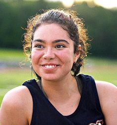 a young woman is smiling for the camera