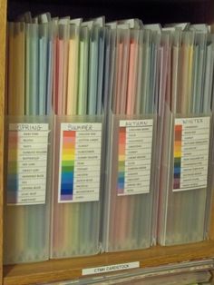 a wooden shelf filled with lots of different colored papers