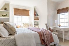 a bedroom with a bed, desk and window in it's centerpieces