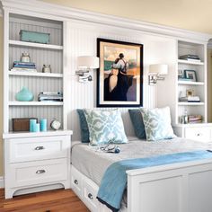 a white bed sitting in a bedroom next to a dresser and bookcase filled with books