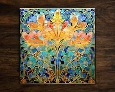 an art nouveau style stained glass panel with flowers and leaves on the bottom, against a dark wood background