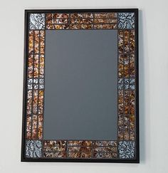 a decorative mirror mounted to the side of a wall