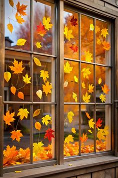 autumn leaves are falling out of the window