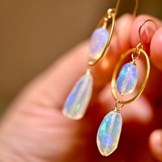 Atlantis Drops earrings are made woth gorgeous opals that look like they were formed from the magical waters of Atlantis. These opals display a blue hue with a rainbow flash inside. These have 4 spectacular opals and fhey are accenting with the finest gold vermeil hoops. Golden Circles - Gold Vermeil (over .925 sterling silver) Ethiopian Opals Top Opals: 12 x 9 mm Large Bottom Opals: - 18 x 9 mm 14 K Gold Filled Ear Wire Length: 2” Iridescent Opal Round Jewelry, Iridescent Round Opal Jewelry, Iridescent Opal Jewelry, Nickel-free Oval Opal Jewelry, Unique Iridescent Opal Jewelry, Oval Opal Jewelry With Matching Earrings, Handmade Ethiopian Opal Elegant Jewelry, Handmade Opal Drop Earrings, Hypoallergenic Opal Dangle Earrings