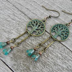 "If you are down to earth and prefer the simple life these woodland beaded dangle earrings are just for you. The turquoise green patina brass tree of life charms provides an earthy contrast to the faceted Czech glass teardrop beads. Your spirits are guaranteed to be lighten with these soulful handmade earrings that sway harmoniously with movement.   Earrings are measured from the base of the earwire 4 Small pairs in stock - 17 x 20mm Tree of Life Charm and 1 5/8\" in length 2 Large pairs in stoc Nature-inspired Jewelry With Dangling Beads For Gifts, Green Rustic Dangle Earrings, Rustic Green Dangle Earrings, Nature-inspired Beaded Dangle Earrings As Gift, Nature-inspired Dangle Beaded Earrings As Gift, Nature-inspired Dangle Beaded Earrings For Gift, Handmade Nature-inspired Dangle Beaded Earrings, Earthy Beaded Dangle Earrings As Gift, Rustic Dangle Earrings As A Gift