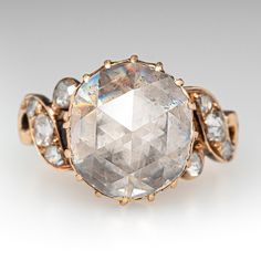 an image of a ring that is made with gold and white stones on the side