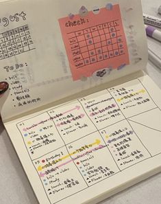 an open notebook with a calendar on it and some writing paper attached to the cover