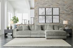 a living room filled with furniture and a brick wall