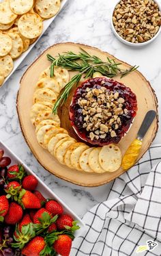 a cheese board with fruit and crackers on it