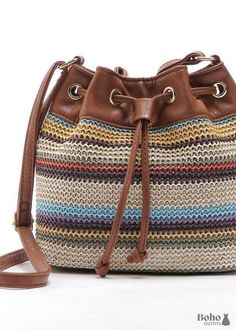 a multicolored bucket bag with a brown leather strap and drawstrings