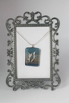 a silver frame with a glass pendant on it